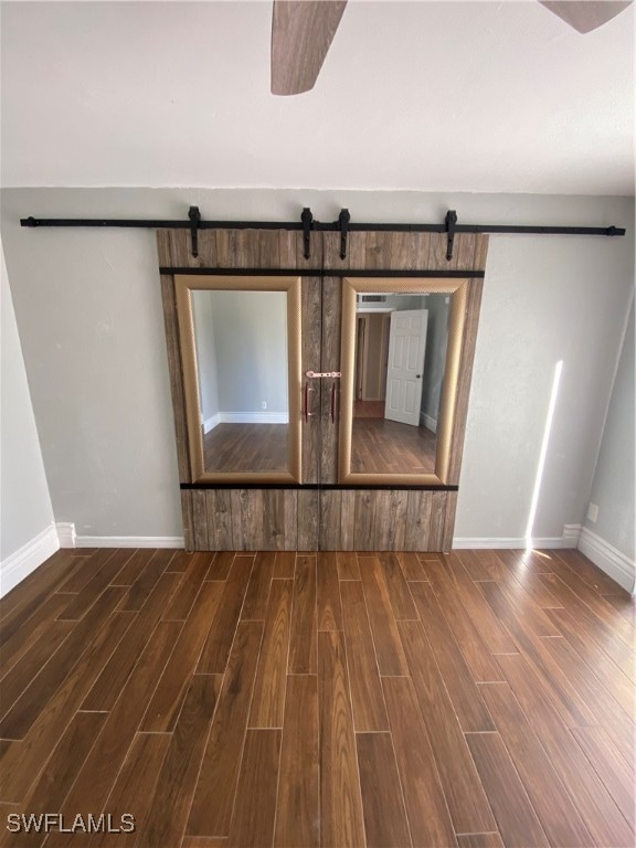 unfurnished living room with dark hardwood / wood-style flooring