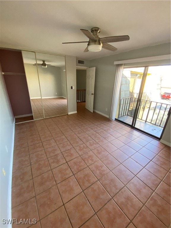 unfurnished bedroom with access to exterior, a closet, ceiling fan, and light tile patterned flooring