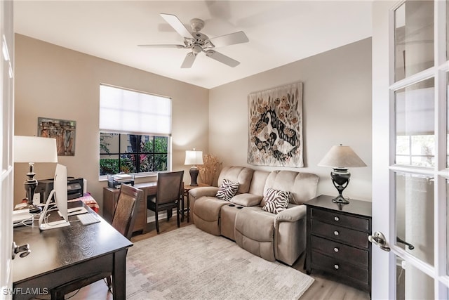 living room with ceiling fan, a healthy amount of sunlight, and light hardwood / wood-style floors