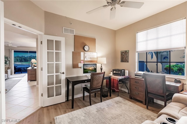 home office with ceiling fan and light wood-type flooring