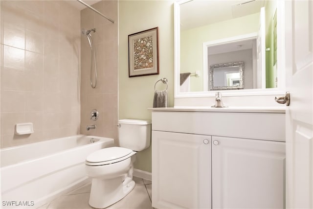 full bathroom featuring tile patterned floors, tiled shower / bath combo, toilet, and vanity