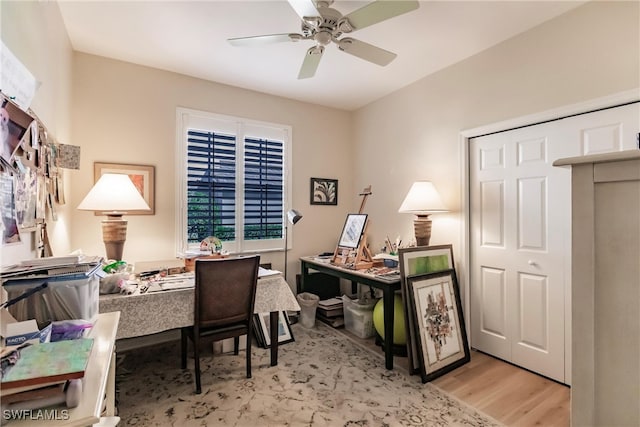 office area with ceiling fan and light hardwood / wood-style floors