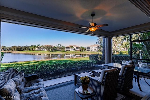 view of patio / terrace with ceiling fan, a water view, and an outdoor living space