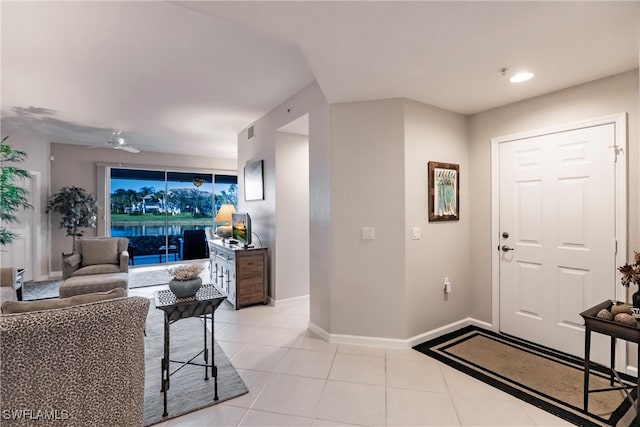 tiled entrance foyer with ceiling fan