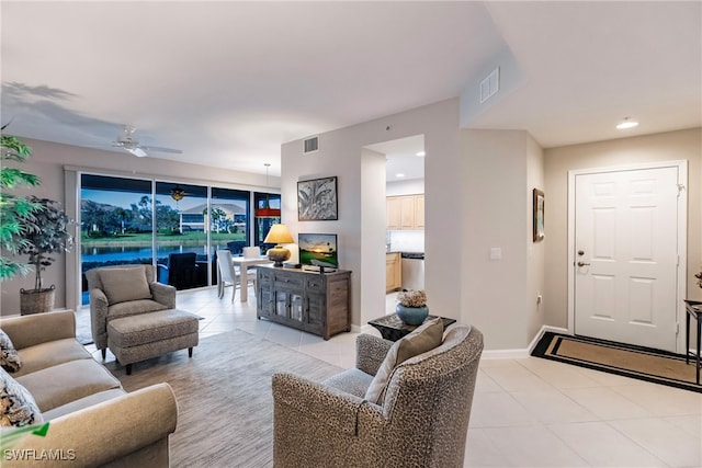 tiled living room with ceiling fan