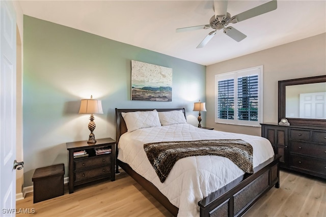 bedroom with light hardwood / wood-style flooring and ceiling fan