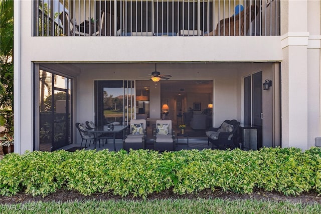 property entrance with ceiling fan and a balcony