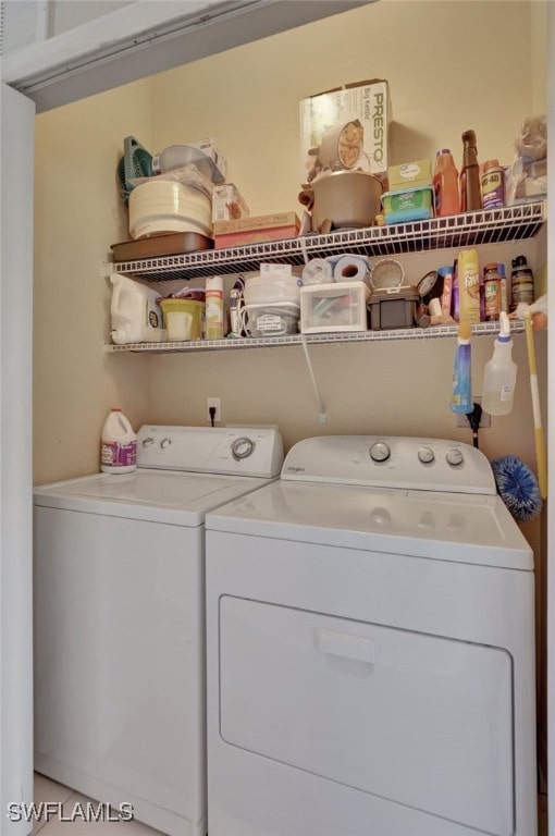 laundry room featuring washing machine and clothes dryer