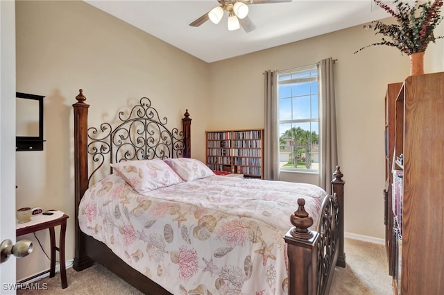 bedroom with ceiling fan and light carpet