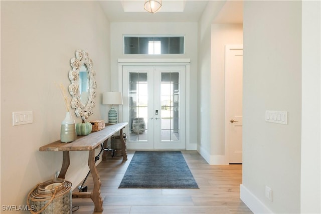 14248 Laguna Springs Ln, Naples, FL 34114 - foyer entrance with french doors, light wood-style flooring, and baseboards