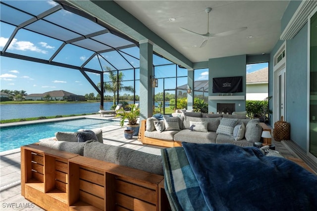 14248 Laguna Springs Ln, Naples, FL 34114 - view of patio / terrace with an outdoor living space with a fireplace, a water view, an outdoor pool, and ceiling fan