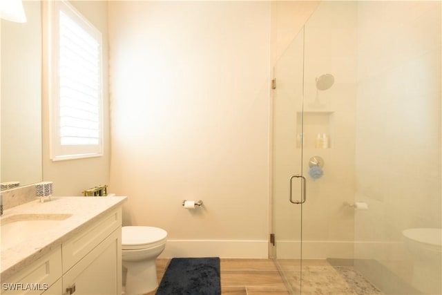 14248 Laguna Springs Ln, Naples, FL 34114 - full bath with toilet, vanity, a stall shower, and baseboards