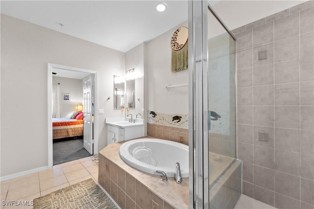 full bathroom with vanity, a shower stall, a bath, tile patterned floors, and ensuite bath