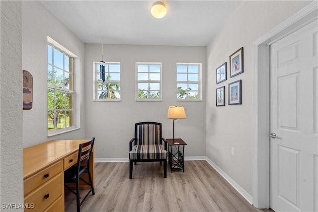 sitting room featuring light wood-type flooring and baseboards