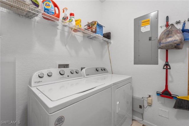 clothes washing area with laundry area, washer and clothes dryer, and electric panel