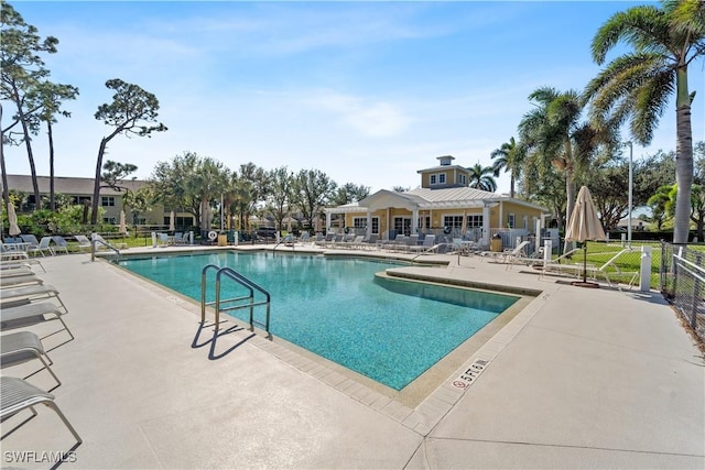 pool featuring a patio area and fence