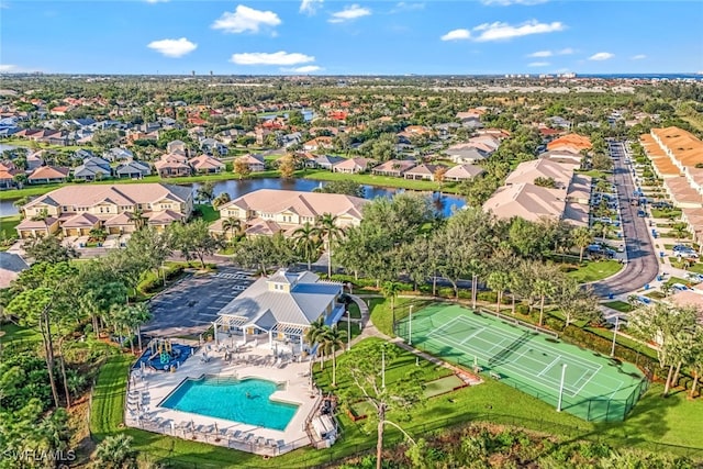 drone / aerial view featuring a residential view and a water view