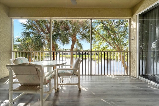 unfurnished sunroom with a water view and a healthy amount of sunlight