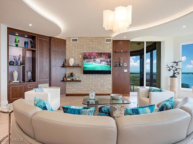 living room featuring an inviting chandelier and light hardwood / wood-style flooring