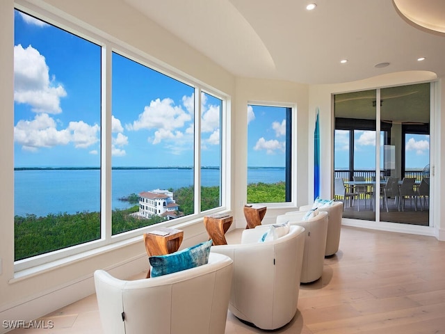 sunroom / solarium featuring a water view and a wealth of natural light