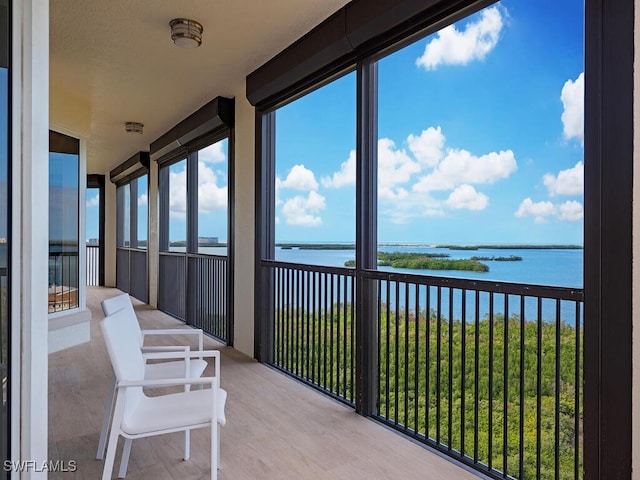 sunroom / solarium with a water view