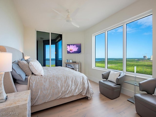 bedroom with ceiling fan and light hardwood / wood-style floors