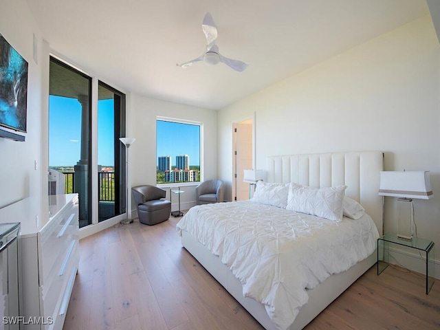 bedroom with ceiling fan, light wood-type flooring, and access to outside