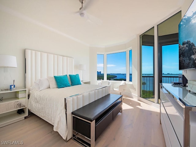 bedroom with access to outside, crown molding, ceiling fan, light wood-type flooring, and a wall of windows