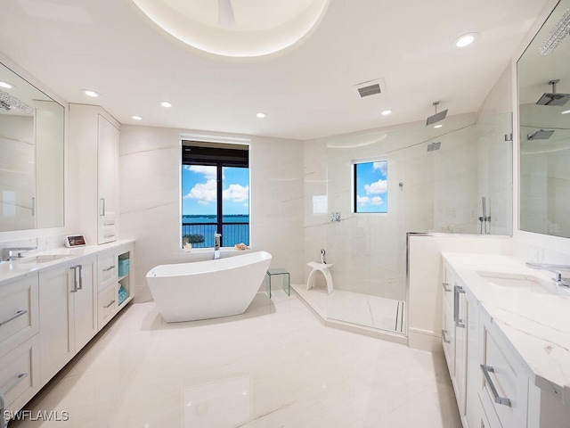 bathroom with vanity and independent shower and bath