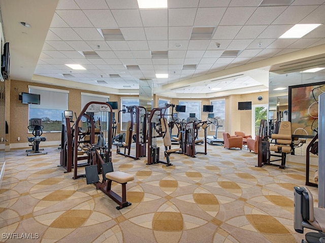 workout area with a paneled ceiling and plenty of natural light