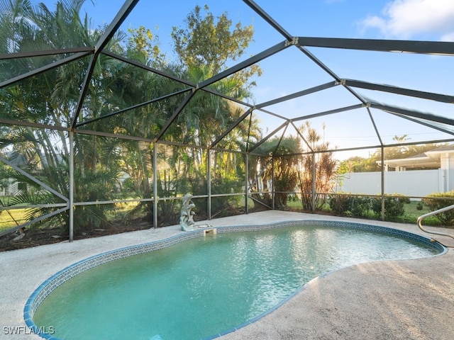 view of swimming pool featuring a lanai and a patio