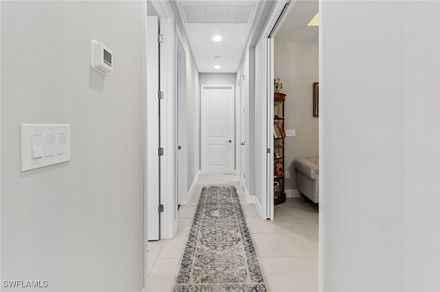 hall with light tile patterned floors