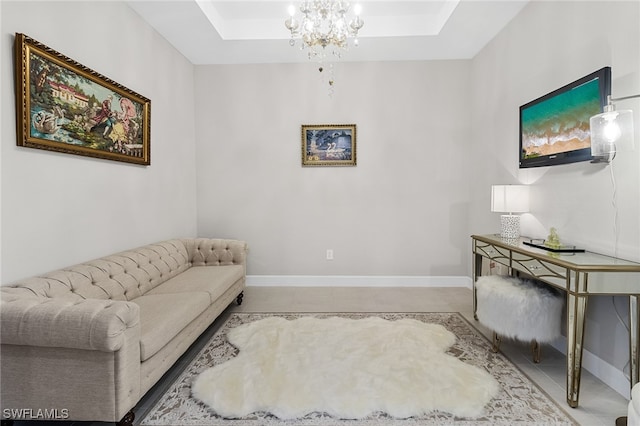 living room with a raised ceiling and an inviting chandelier