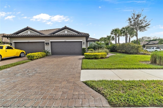 view of front of house with a front yard and a garage