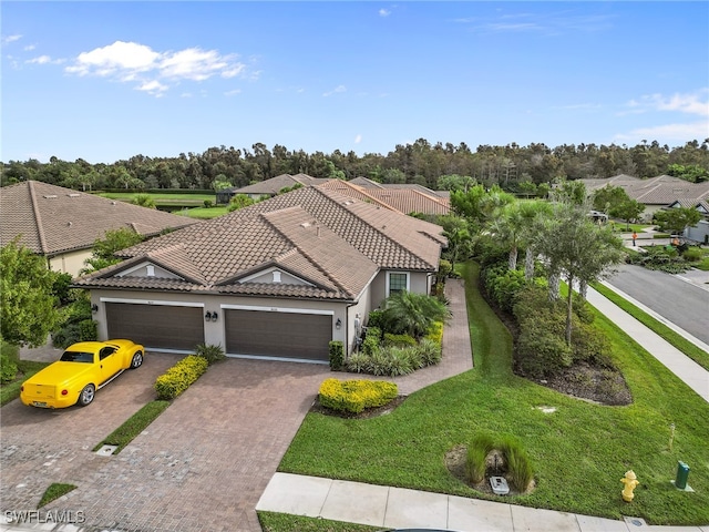 mediterranean / spanish home with a garage and a front yard