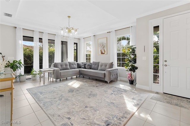 living room featuring a chandelier, light tile patterned floors, a raised ceiling, and crown molding