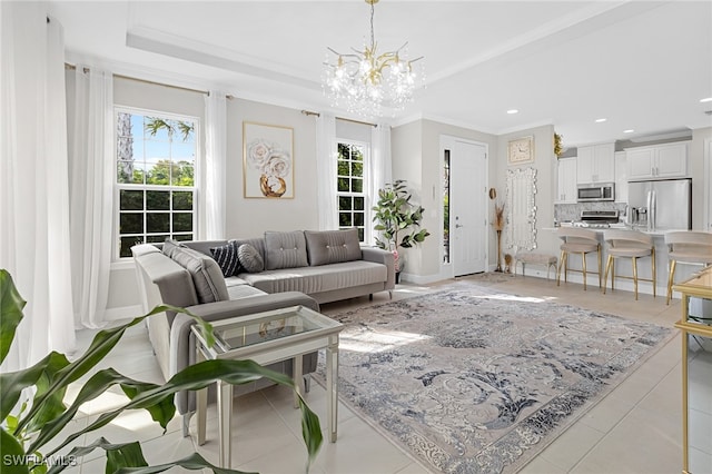 living room featuring light tile patterned floors, a chandelier, and ornamental molding