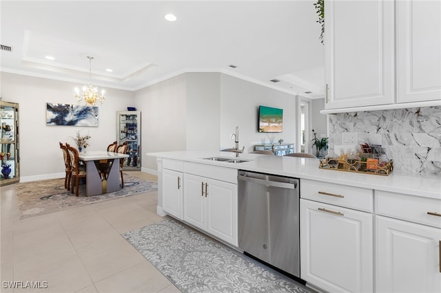 kitchen featuring white cabinets, tasteful backsplash, sink, dishwasher, and hanging light fixtures