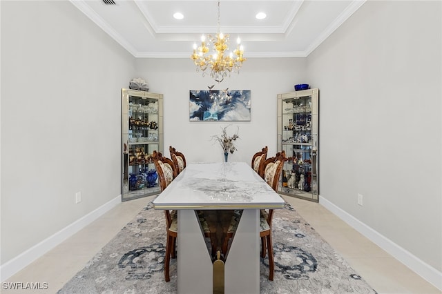 dining area featuring a raised ceiling, light tile patterned floors, ornamental molding, and an inviting chandelier