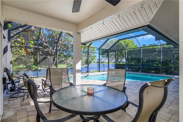 view of pool featuring a patio area, ceiling fan, and a lanai