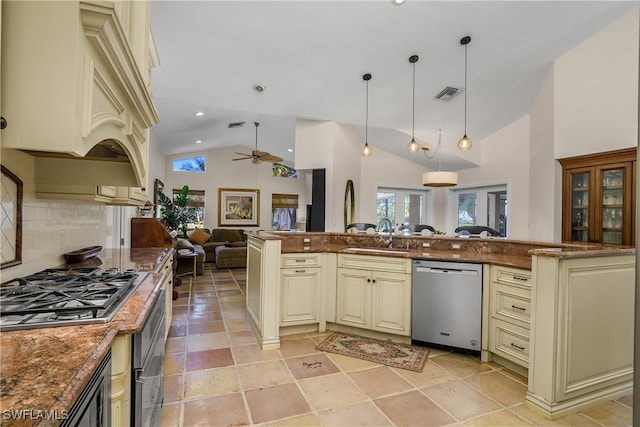 kitchen featuring cream cabinetry, sink, hanging light fixtures, and appliances with stainless steel finishes