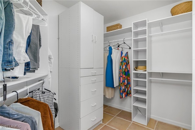 spacious closet featuring light tile patterned floors