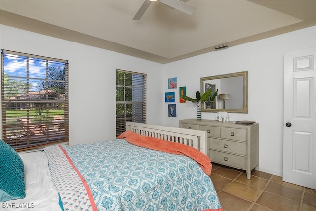 tiled bedroom featuring ceiling fan