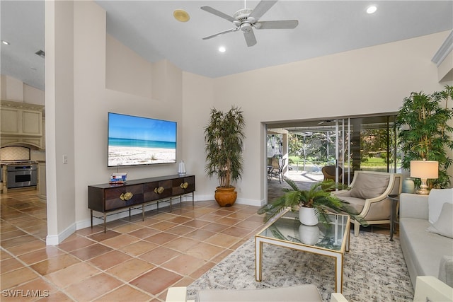 tiled living room featuring ceiling fan and high vaulted ceiling