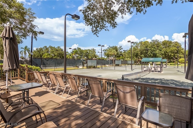 wooden deck with tennis court