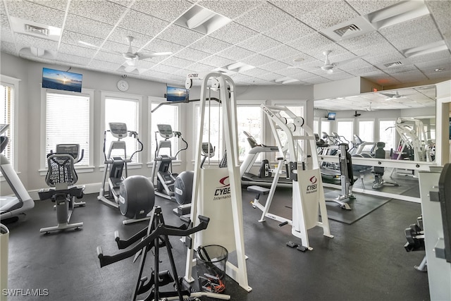 gym with ceiling fan and a drop ceiling