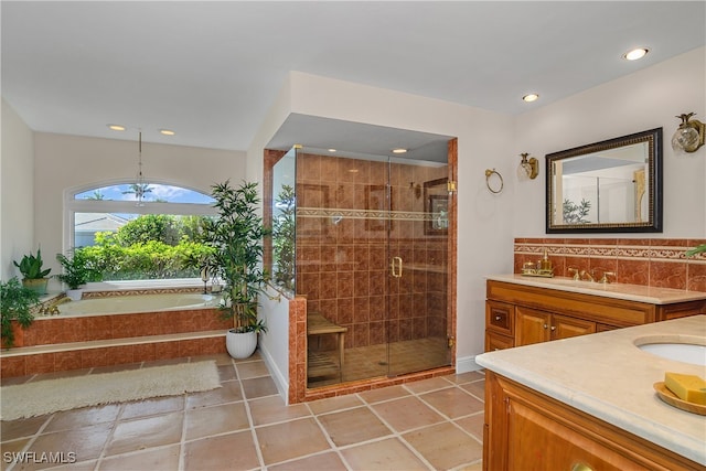 bathroom with tile patterned floors, a chandelier, decorative backsplash, vanity, and independent shower and bath