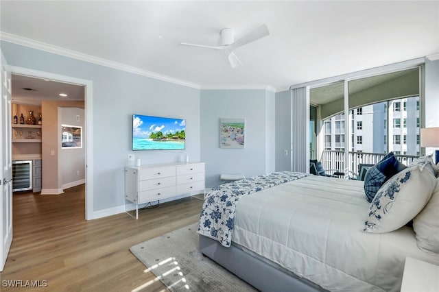 bedroom featuring ceiling fan, beverage cooler, light hardwood / wood-style floors, and ornamental molding