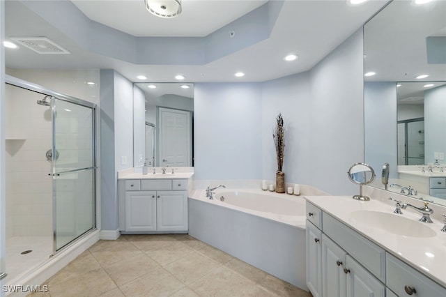 bathroom featuring plus walk in shower, vanity, and tile patterned floors