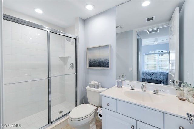 bathroom featuring vanity, toilet, and walk in shower